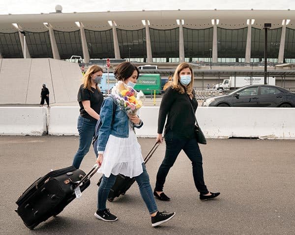 Nicole Carroll leads Fatema Hosseini out of Dulles International Airport