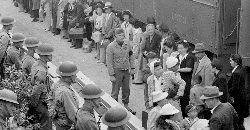 Japanese Americans arrive by train