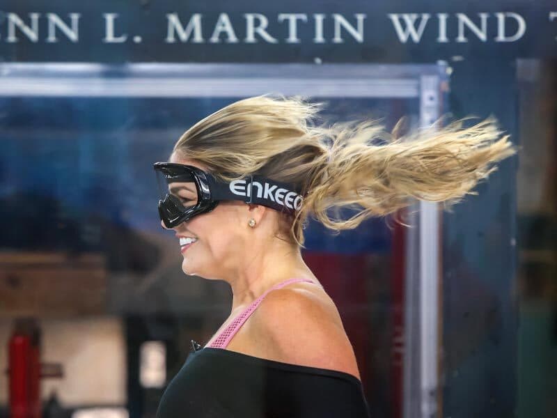 woman's hair blows in wind tunnel