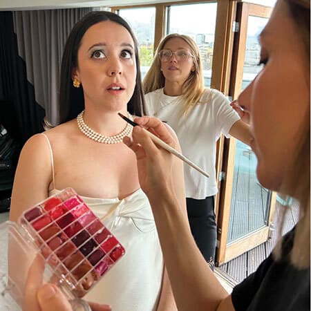 bride gets makeup done for wedding